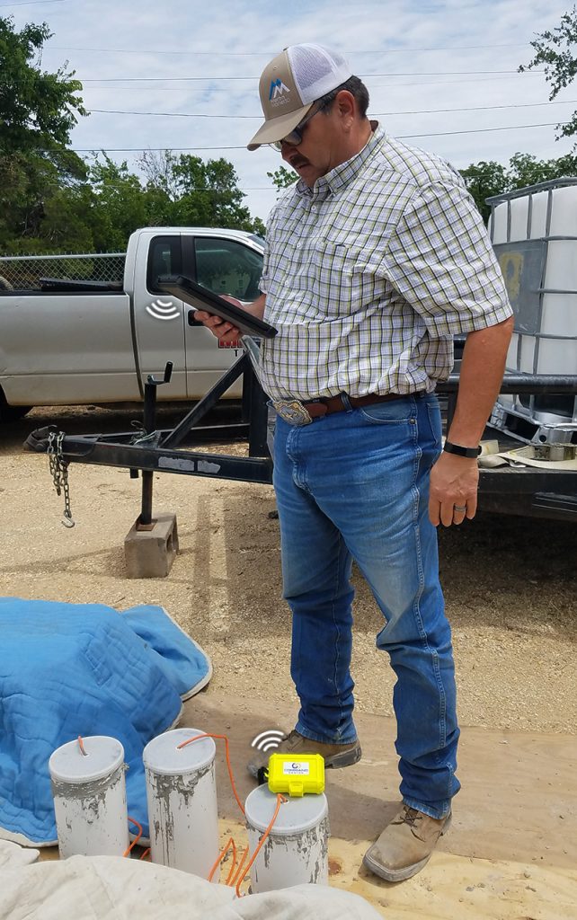 srm-communicating-with-ipad Man using iPad to read sensor data via sensor reader module.